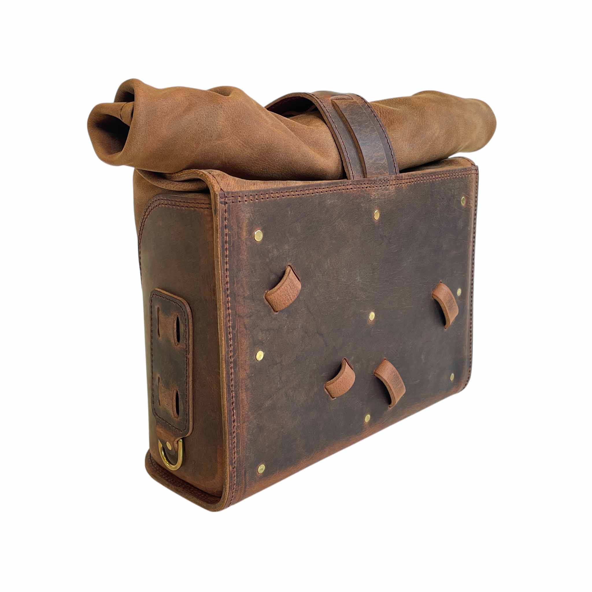 Triumph Bonneville Bobber Panniers Rolltop Swingarm Saddlebags. Hand crafted in USA with premium veg tan water buffalo leather, waterproof liners and solid brass hardware. BAD&G Customs TBP01