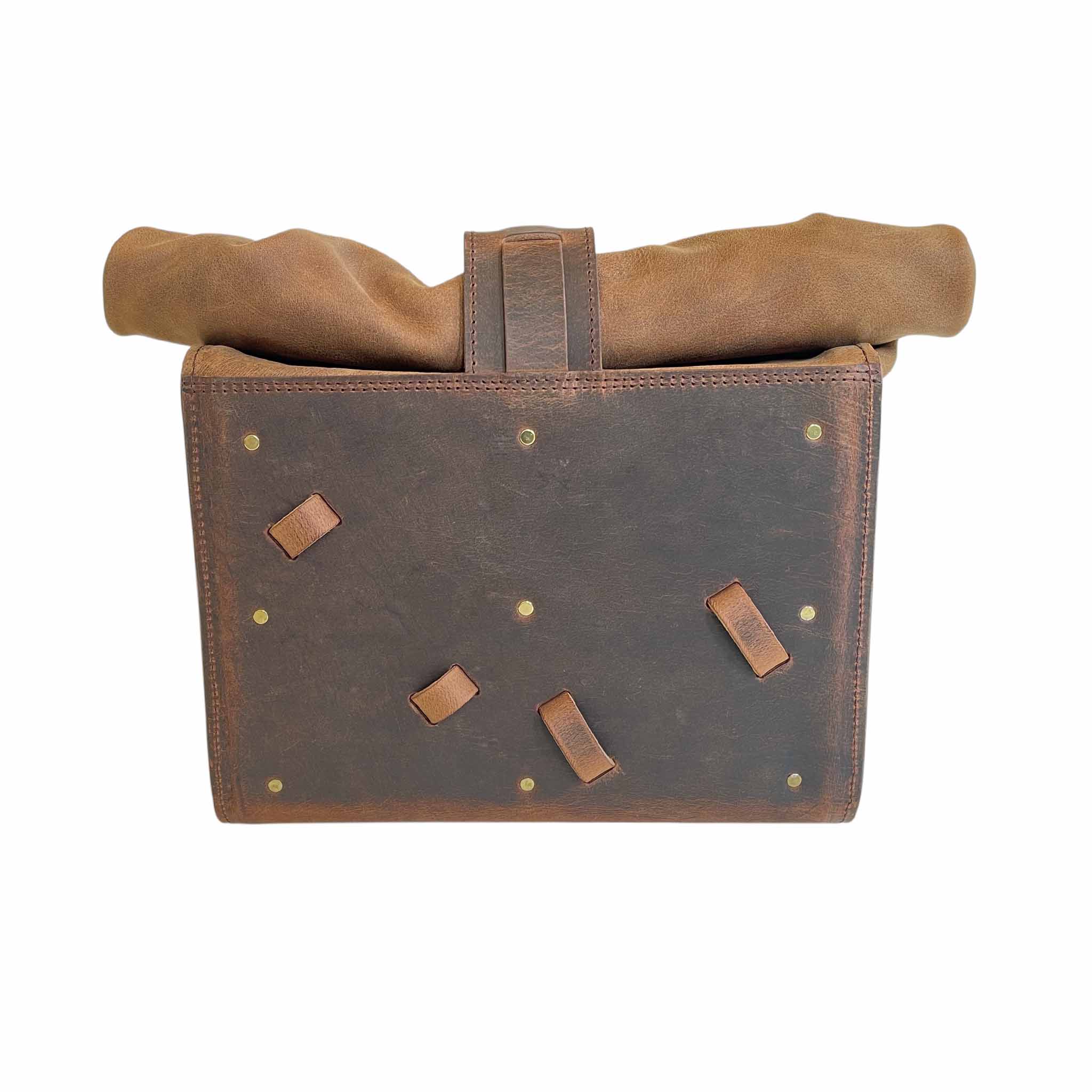 Triumph Bonneville Bobber Panniers Rolltop Swingarm Saddlebags. Hand crafted in USA with premium veg tan water buffalo leather, waterproof liners and solid brass hardware. BAD&G Customs TBP01