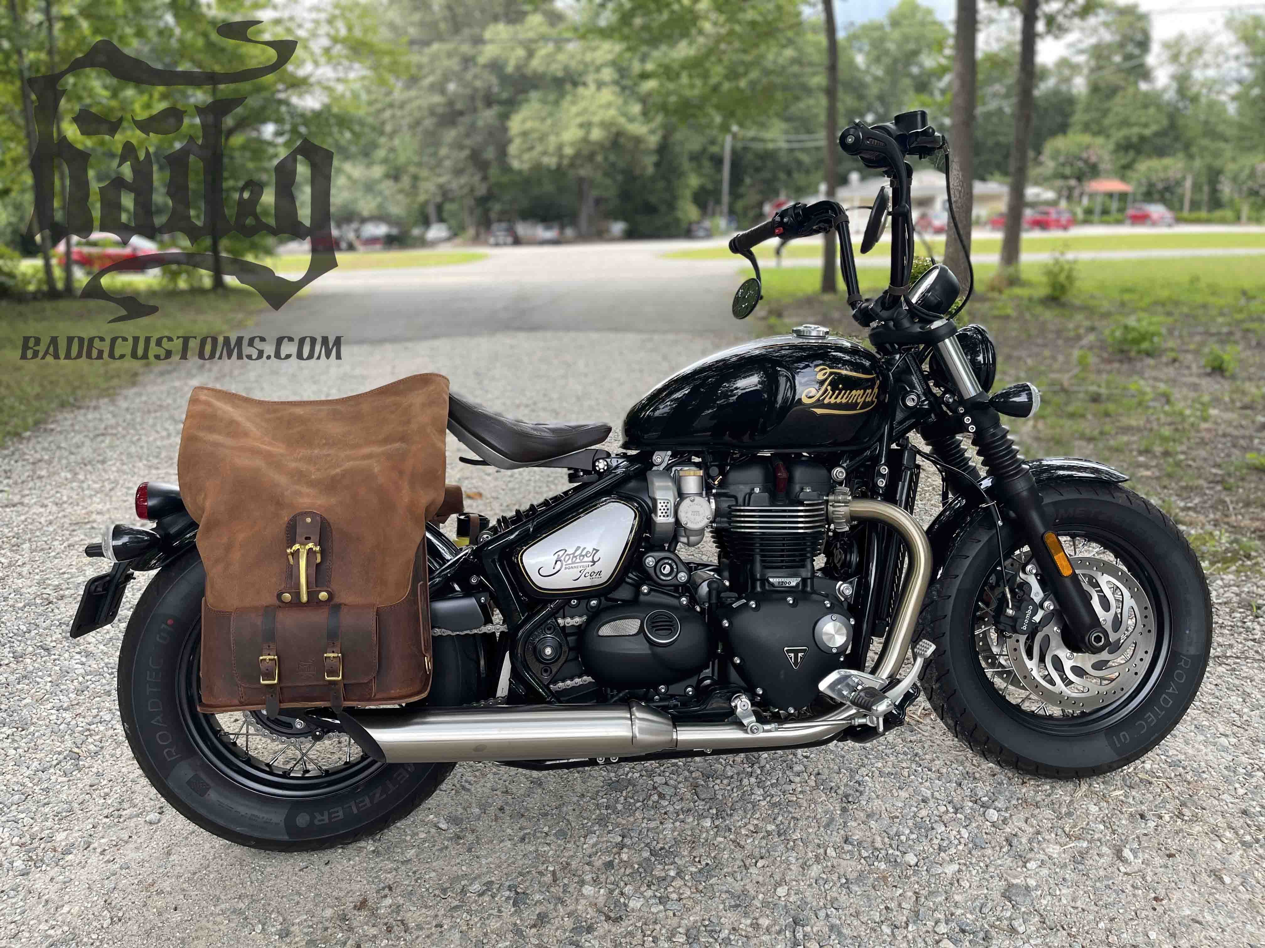 Triumph Bonneville Bobber Panniers Rolltop Swingarm Saddlebags. Hand crafted in USA with premium veg tan water buffalo leather, waterproof liners and solid brass hardware. BAD&G Customs TBP01