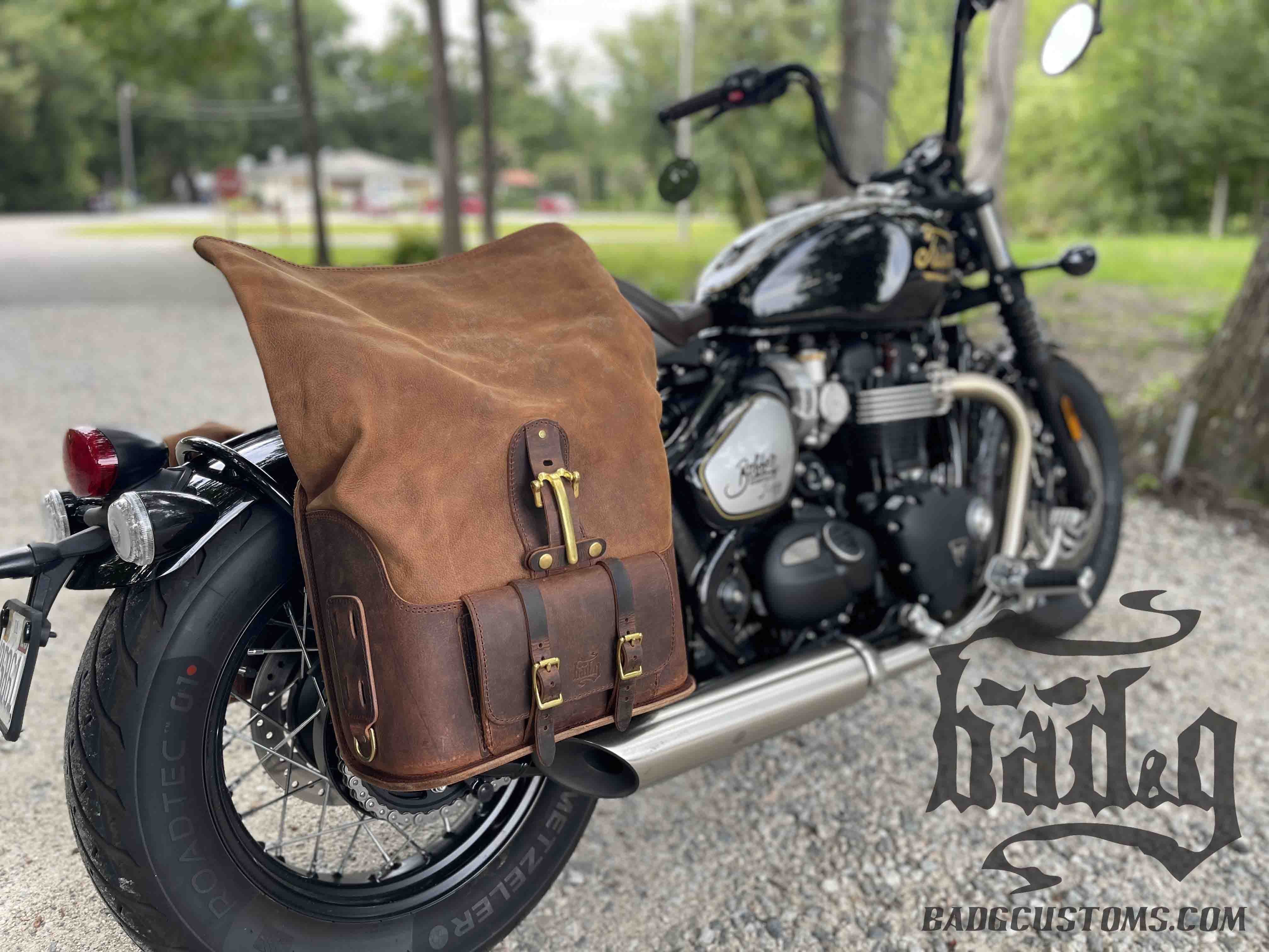 Triumph Bonneville Bobber Panniers Rolltop Swingarm Saddlebags. Hand crafted in USA with premium veg tan water buffalo leather, waterproof liners and solid brass hardware. BAD&G Customs TBP01