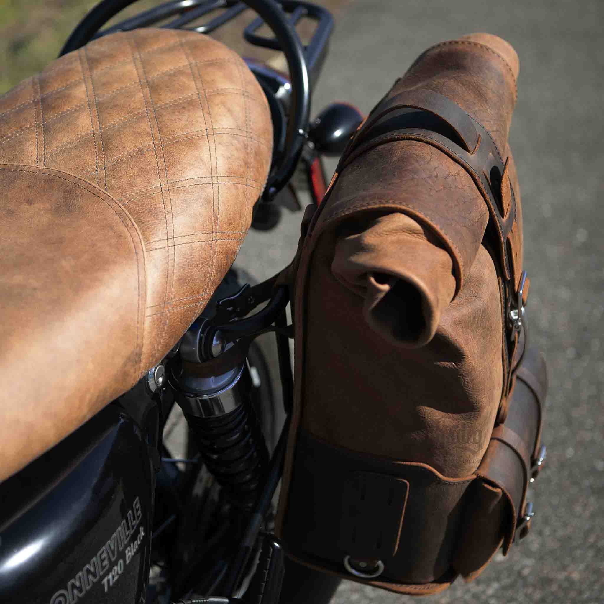 Upgrade your ride with the URB01 Rolltop Backpack Saddlebag. Unique design enables quick conversion from saddlebag to backpack. Hand crafted in USA with premium veg tan water buffalo leather and stainless steel hardware. Durable and stylish, it's the perfect fit for your motorcycle.